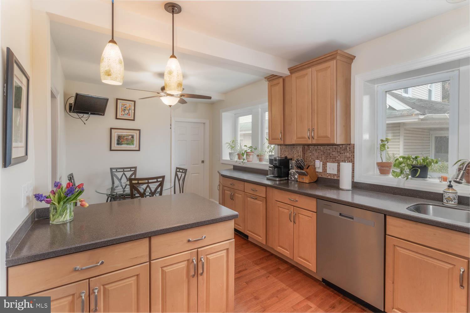 412 Oxford Road Havertown, PA 19083 - Photo 16 of 30 a kitchen with stainless steel appliances a sink a faucet a chandelier and living room view