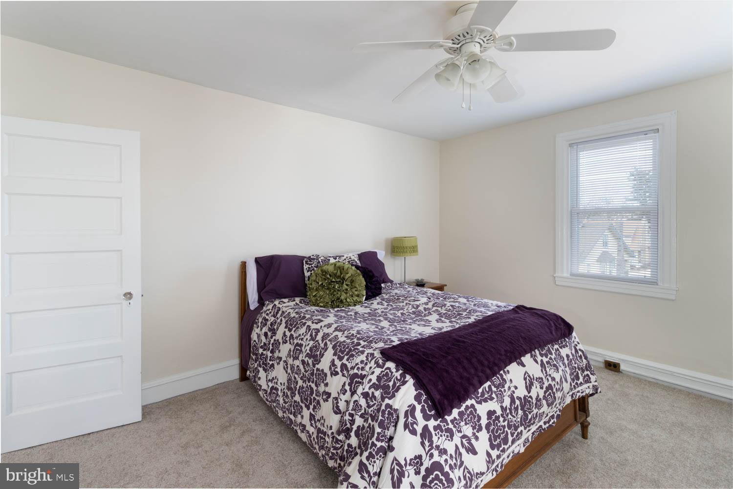 412 Oxford Road Havertown, PA 19083 - Photo 21 of 30 a bedroom with a bed and a chandelier fan