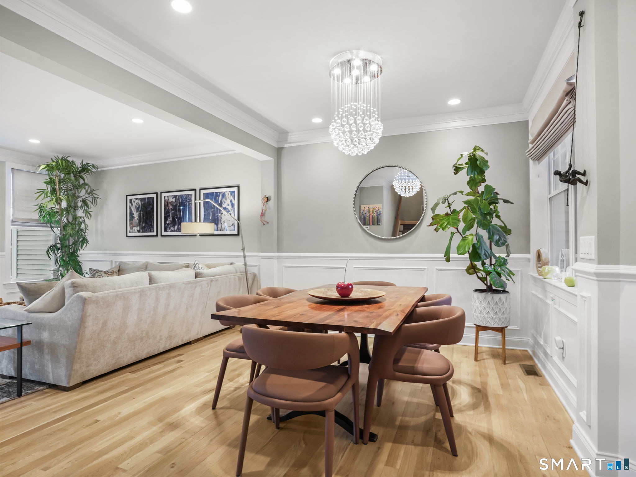 a view of a dining room with furniture and chandelier