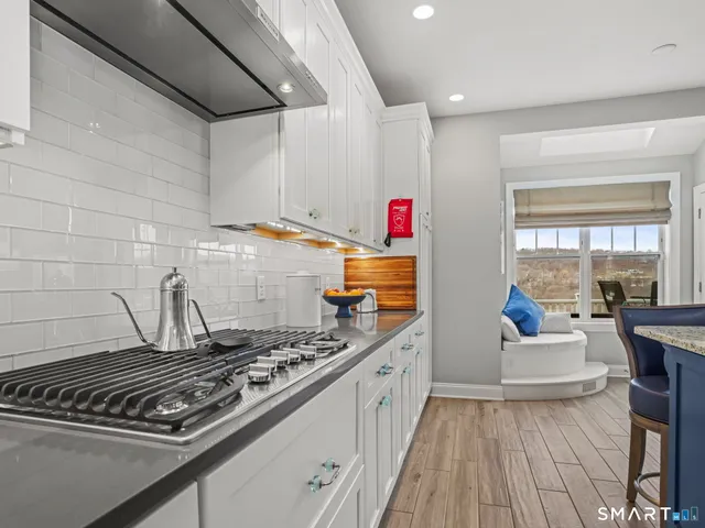 a kitchen with stove and cabinets