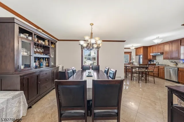 a view of a dining room with furniture and a chandelier