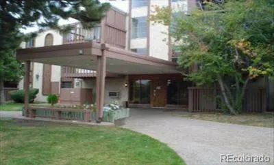 a view of a house with a yard and porch