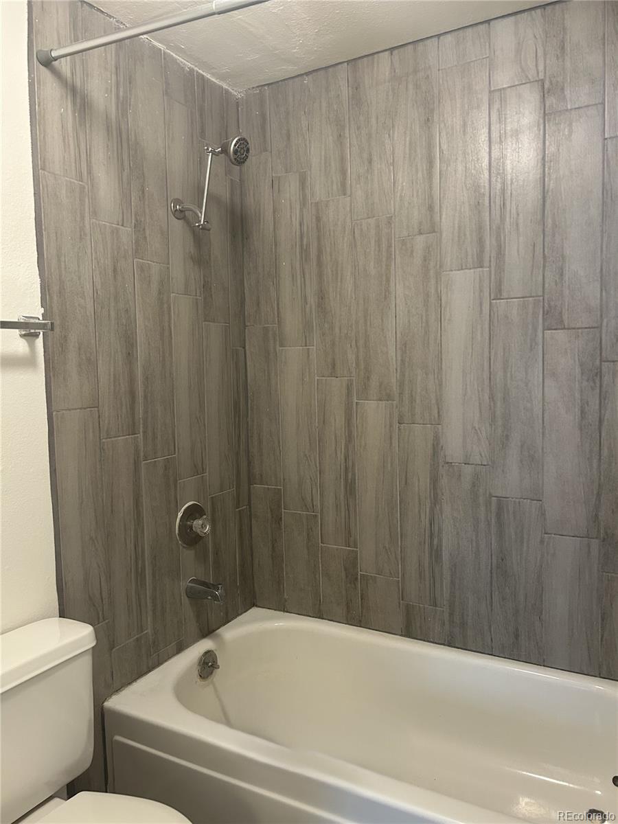 1306 South Parker Road, Unit 167 Denver, CO 80231 - Photo 11 of 26 a bathroom with a shower and a toilet