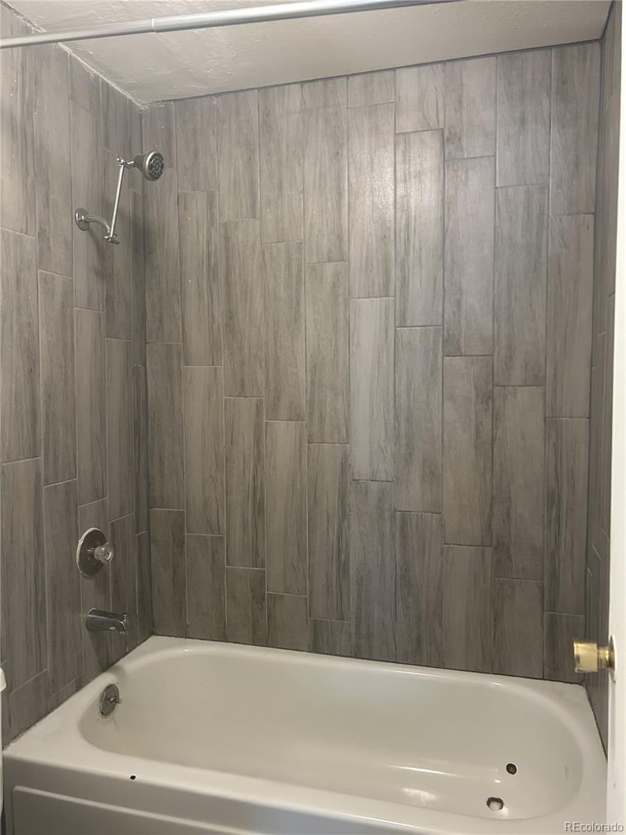 1306 South Parker Road, Unit 167 Denver, CO 80231 - Photo 12 of 26 a bathroom with a shower and a bath tub