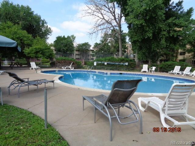 1306 South Parker Road, Unit 167 Denver, CO 80231 - Photo 25 of 26 a view of a swimming pool with outdoor seating and plants