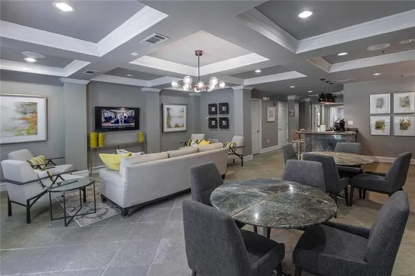 a living room with fireplace furniture and a chandelier
