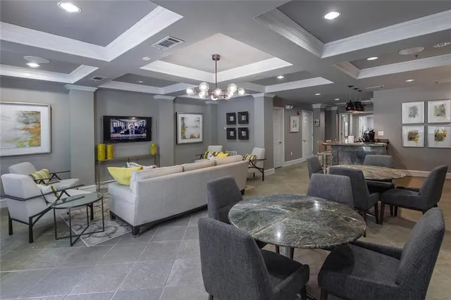 a living room with fireplace furniture and a chandelier