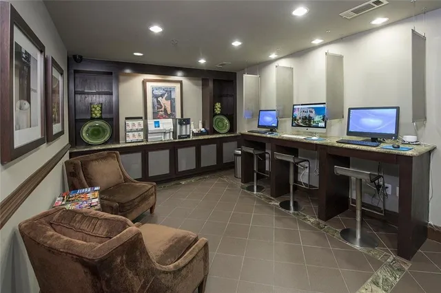 a kitchen with stainless steel appliances granite countertop sink cabinets and wooden floor