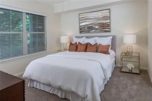 a bedroom with a bed and a night stand