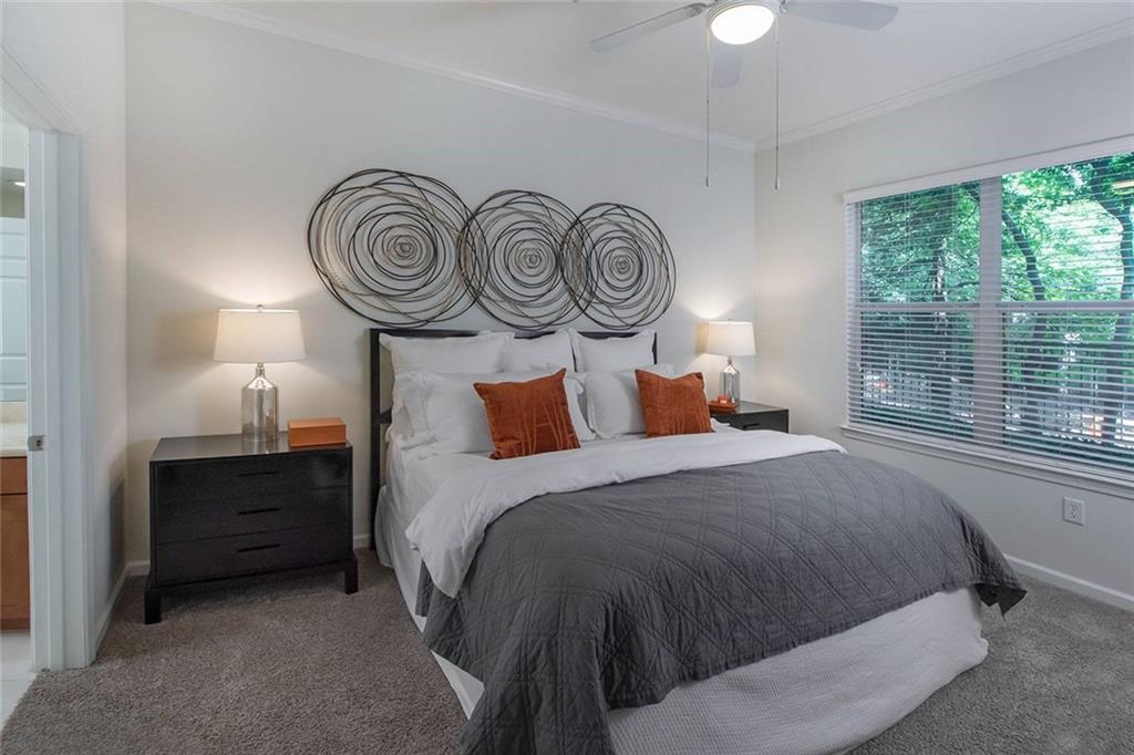 3443 Kingsboro Road Northeast, Unit 1202 Atlanta, GA 30326 - Photo 6 of 17 a bedroom with a bed and a closet