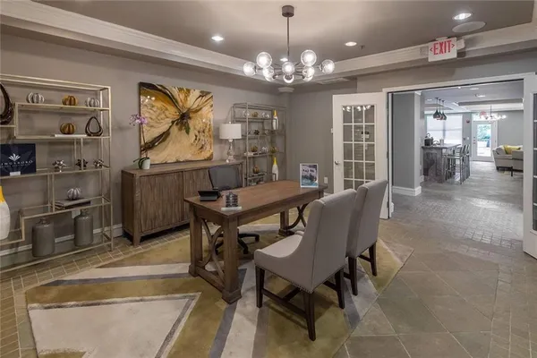 a view of a dining room with furniture and chandelier