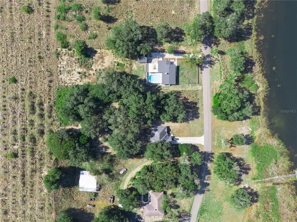 an aerial view of a house with a yard