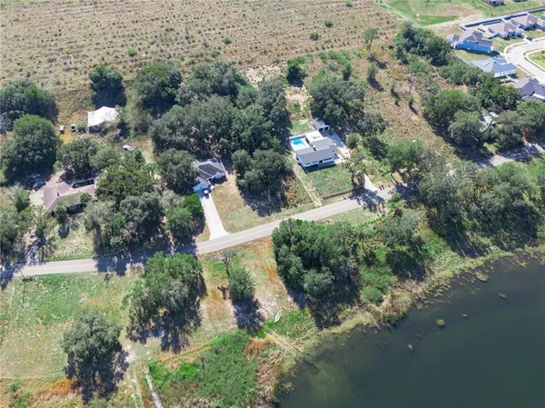 an aerial view of a house with a yard