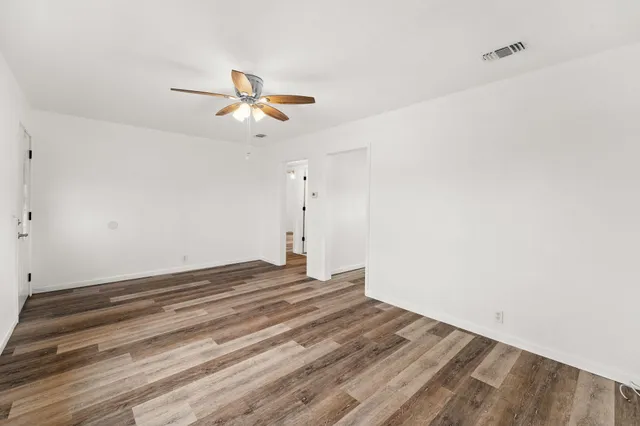 a view of empty room with ceiling fan
