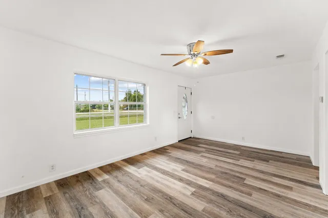 a view of a room with a window and a fan