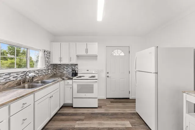 a kitchen with a white cabinets and white appliances