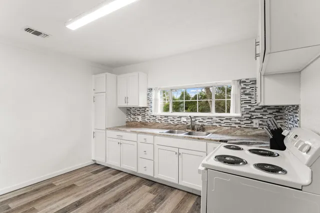 a kitchen that has a sink and a stove