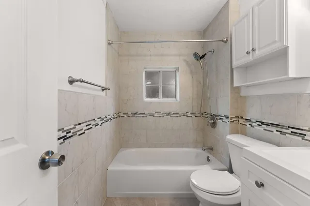 a bathroom with a shower a toilet and sink