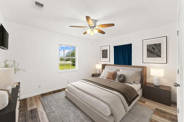 a bedroom with a bed and a chandelier