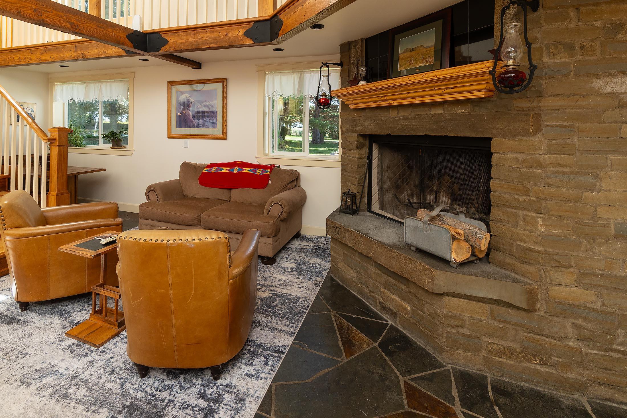 59047 Old Lake Road Christmas Valley, OR 97641 - Photo 36 of 55 Kitchen sitting area with stone slab fireplace