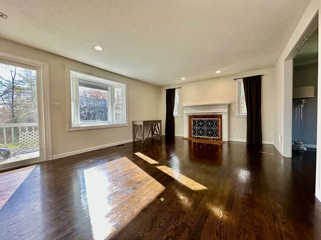 a living room with hardwood floor and a ceiling fan