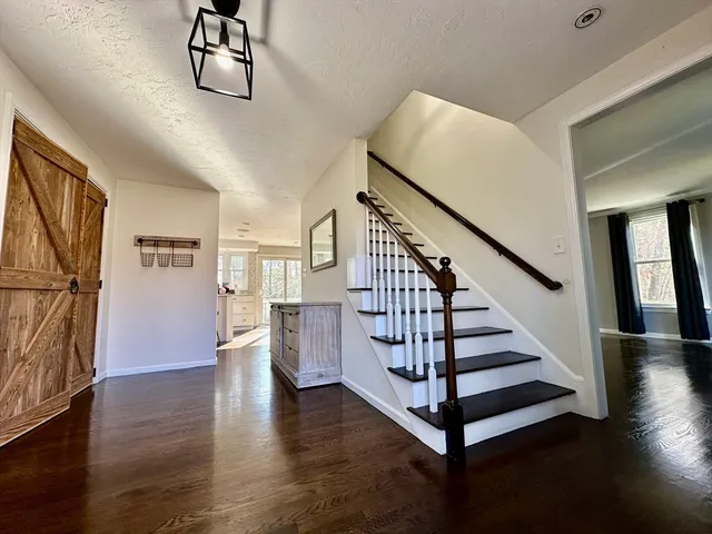 a view of entryway and hall with wooden floor