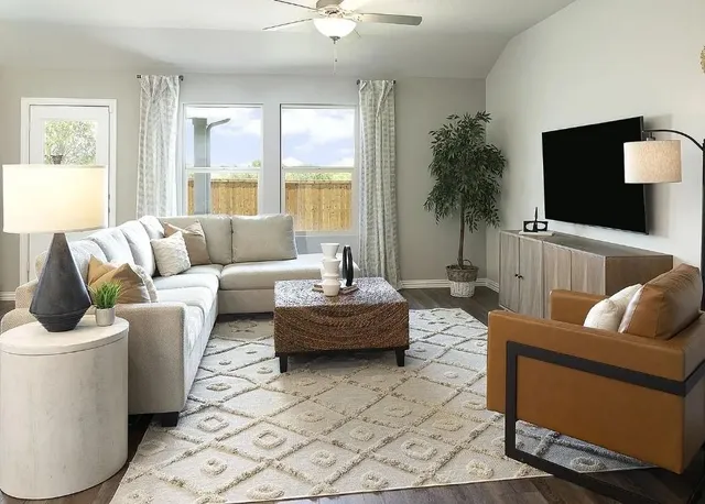 a kitchen with stainless steel appliances a sink a stove a refrigerator cabinets and a dining table