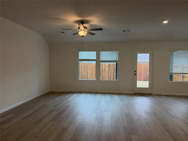 a kitchen with a refrigerator sink and cabinets