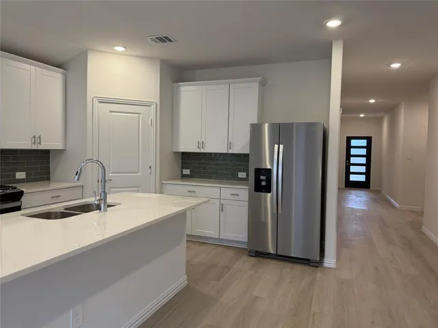 a kitchen with a sink stove and cabinets