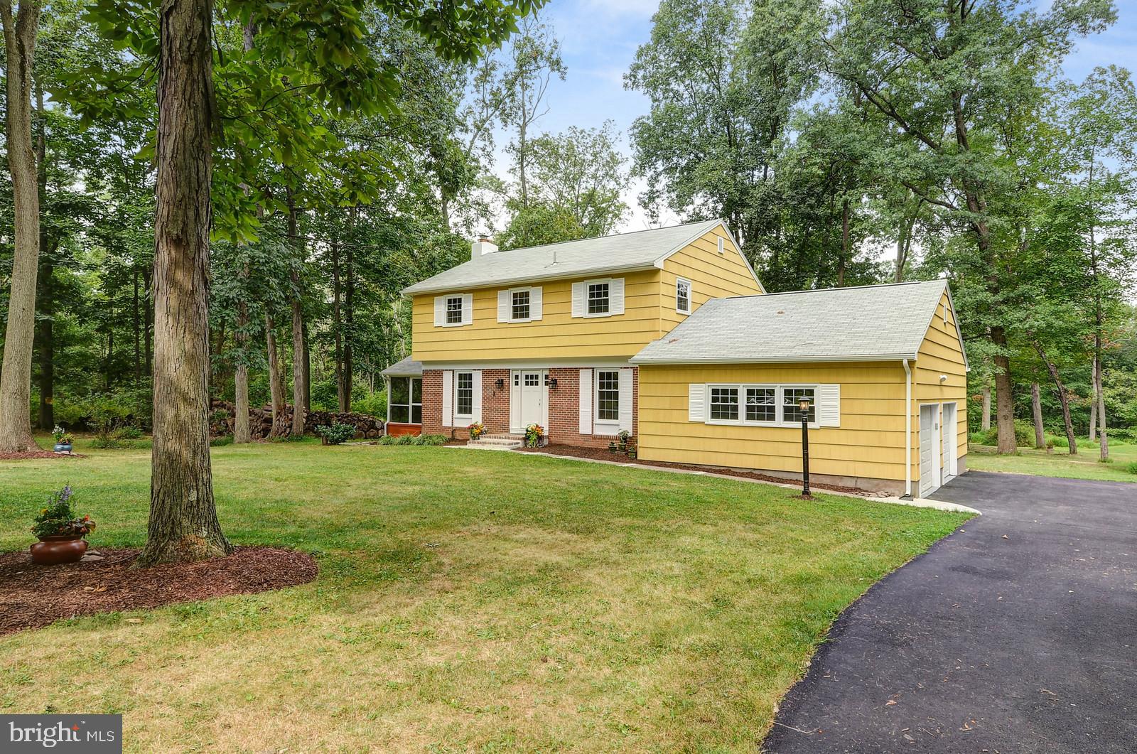 View of driveway and 2-car garage