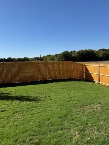 a view of lake with green yard