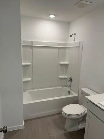 a bathroom with a toilet and a bathtub