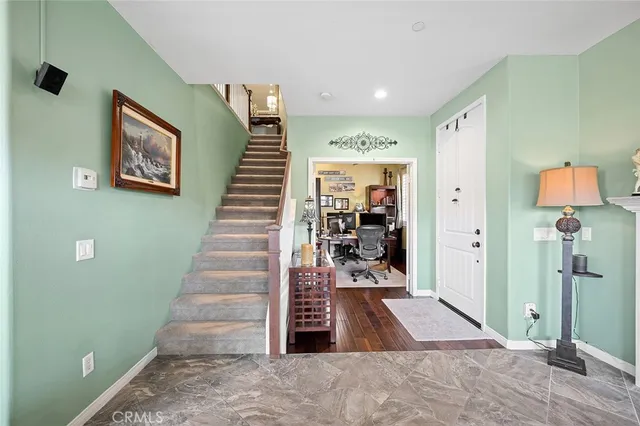 a view of entryway and hall with wooden floor