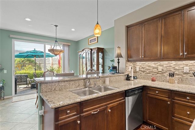 a kitchen with granite countertop cabinets a sink and a stove