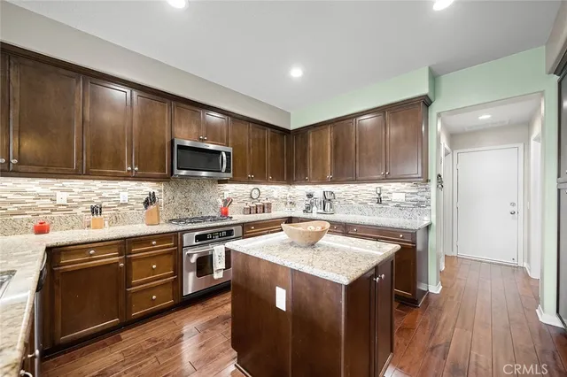 a kitchen with a sink stove top oven and refrigerator