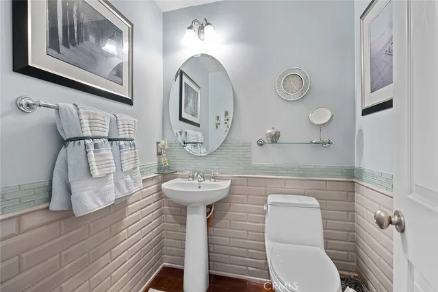 a bathroom with a toilet sink and mirror