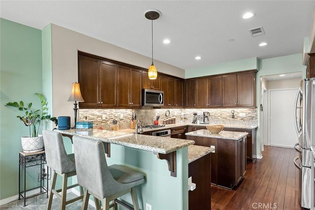 a kitchen with a stove a refrigerator and a dining table