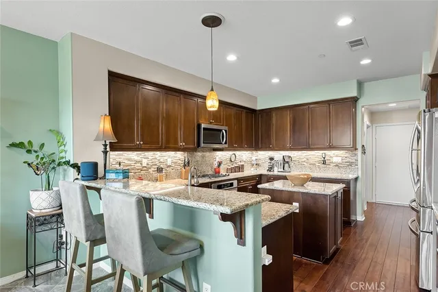 a kitchen with a stove a refrigerator and a dining table