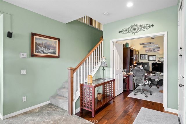 a living room with a fireplace and a wooden floor