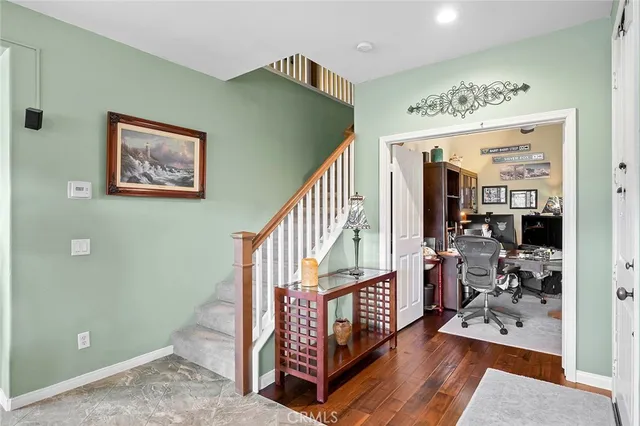 a living room with a fireplace and a wooden floor