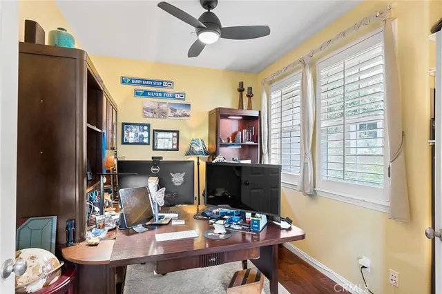 a living room with furniture a chandelier and a large window