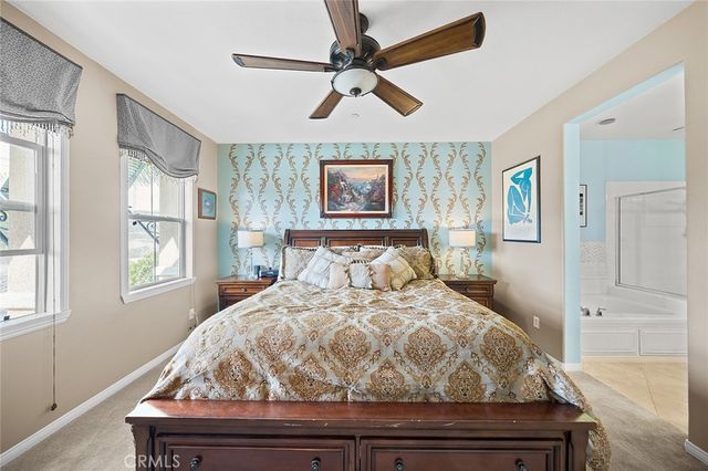 a bedroom with a bed and a painting on the wall