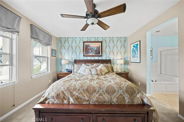 a bedroom with a bed and a painting on the wall