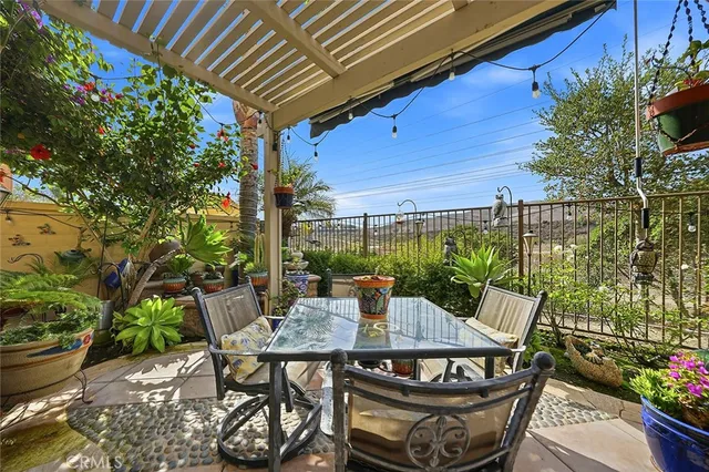 a view of a patio with a table and chairs