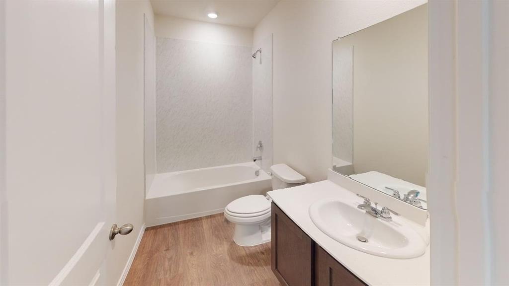 311 Clematis Street Princeton, TX 75407 - Photo 14 of 20 a bathroom with a sink a toilet and shower