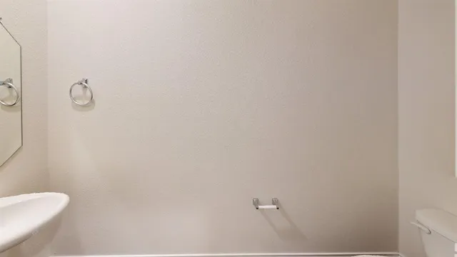 a white toilet sitting next to a shower