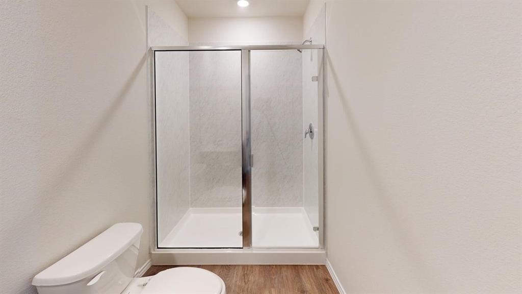 311 Clematis Street Princeton, TX 75407 - Photo 16 of 20 a white toilet sitting next to a shower
