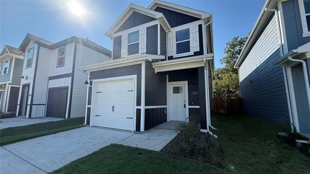 a view of a house with brick walls and a yard