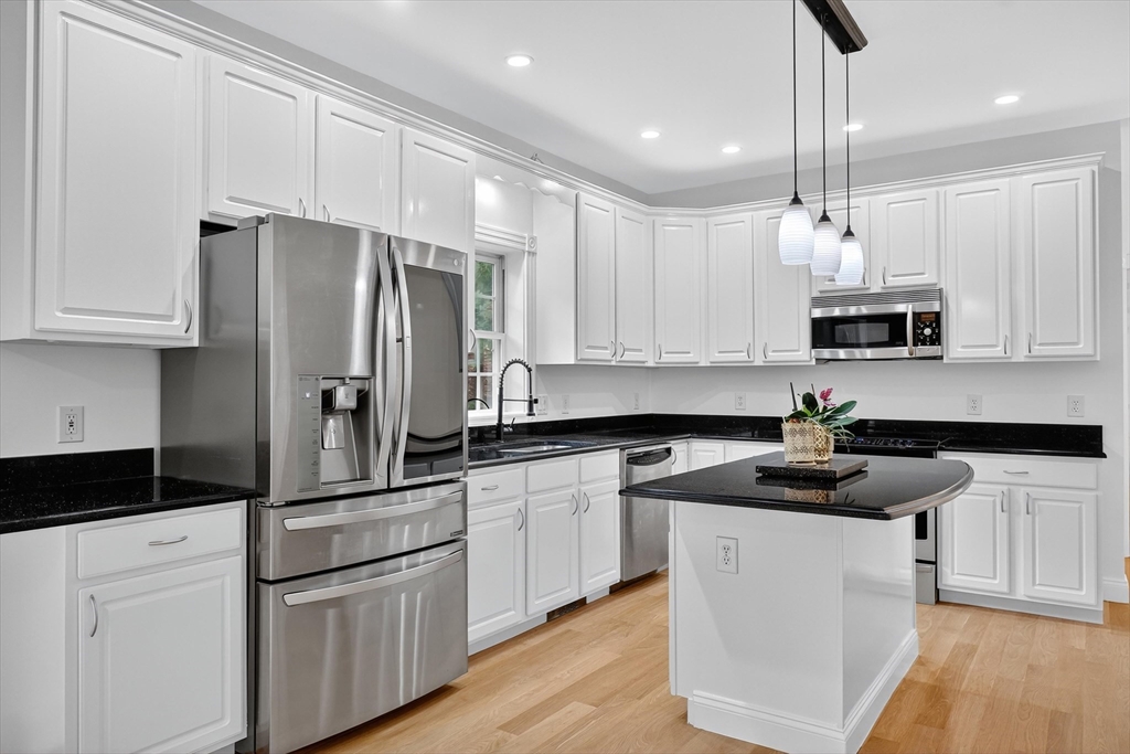 14 Pine Hill Road Framingham, MA 01701 - Photo 15 of 42 a kitchen with white cabinets and stainless steel appliances