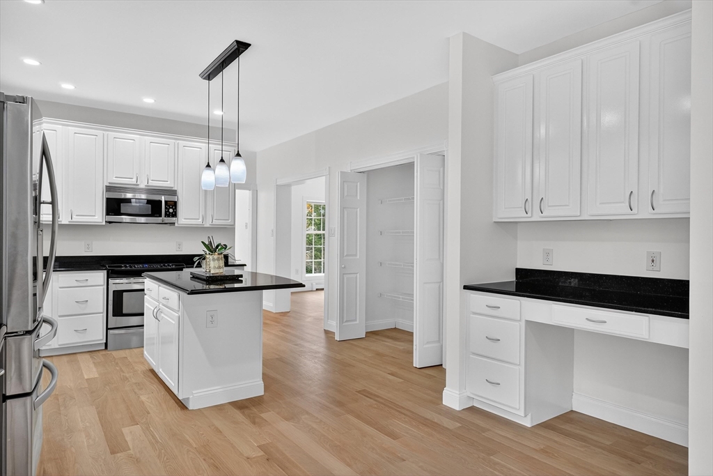 14 Pine Hill Road Framingham, MA 01701 - Photo 16 of 42 a kitchen with stainless steel appliances kitchen island granite countertop a stove a sink and a refrigerator